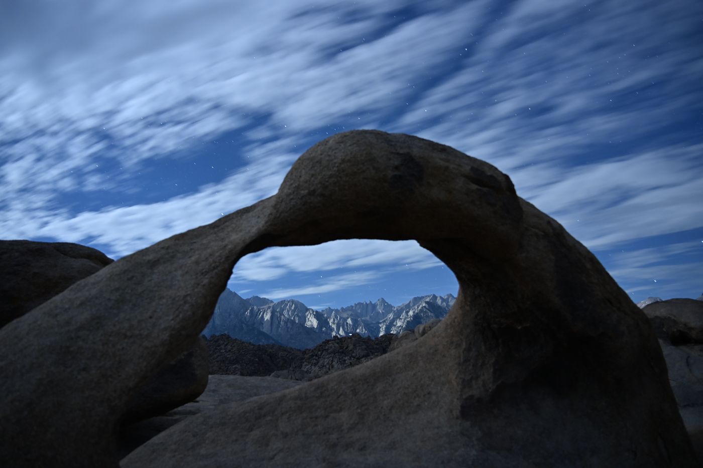 Mobius Arch framing the snow-covered Sierra Nevada crest at first light